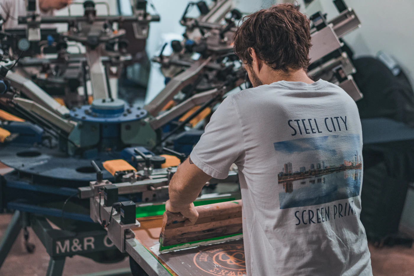 Print specialist working on branded apparel
