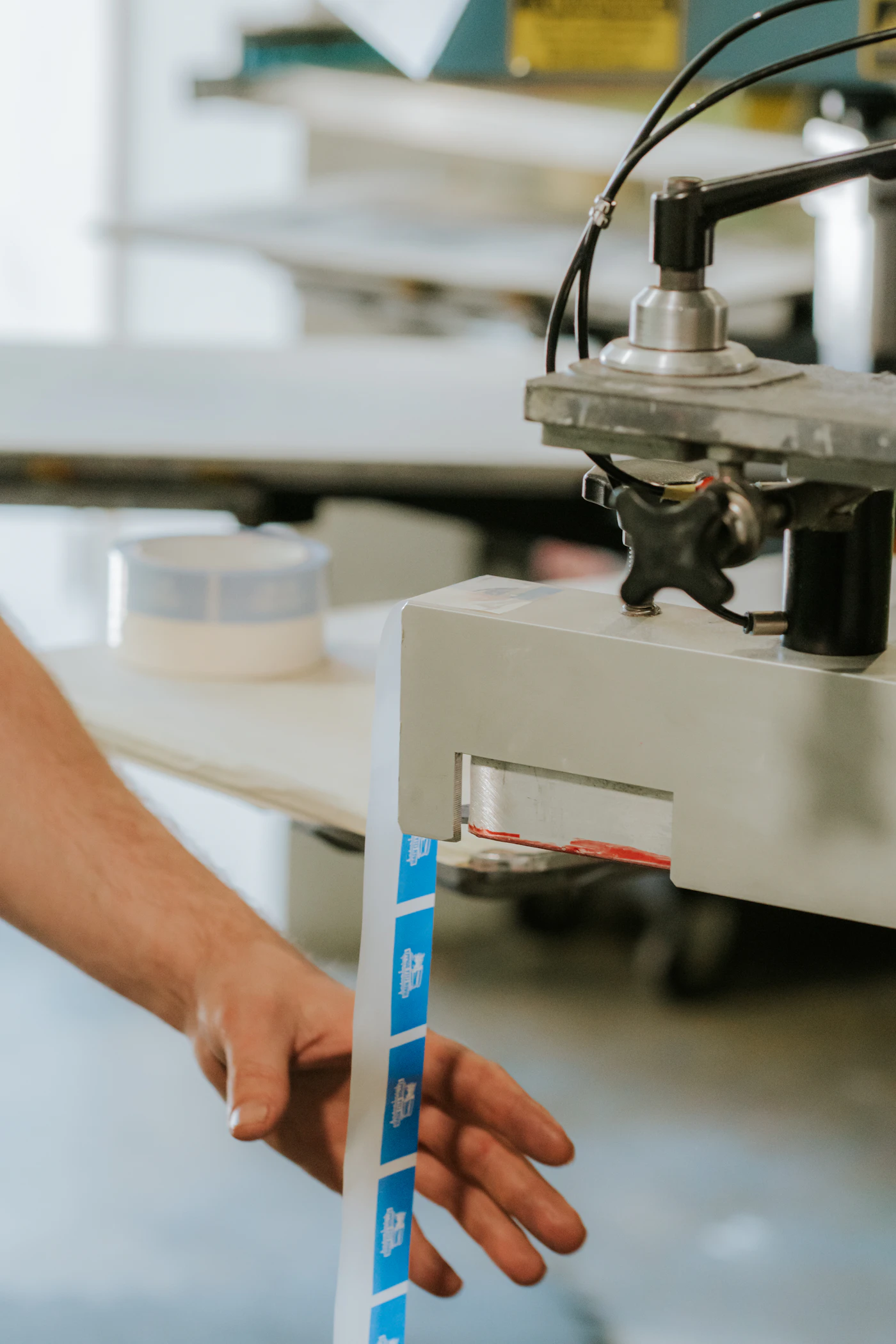 Specialist feeding labels into production equipment