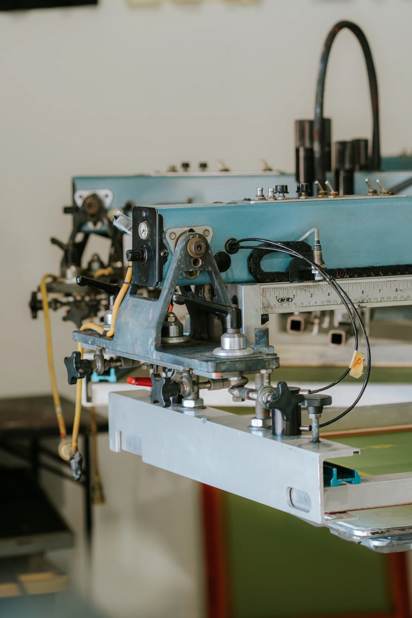 Industrial screen printing press in a production workshop
